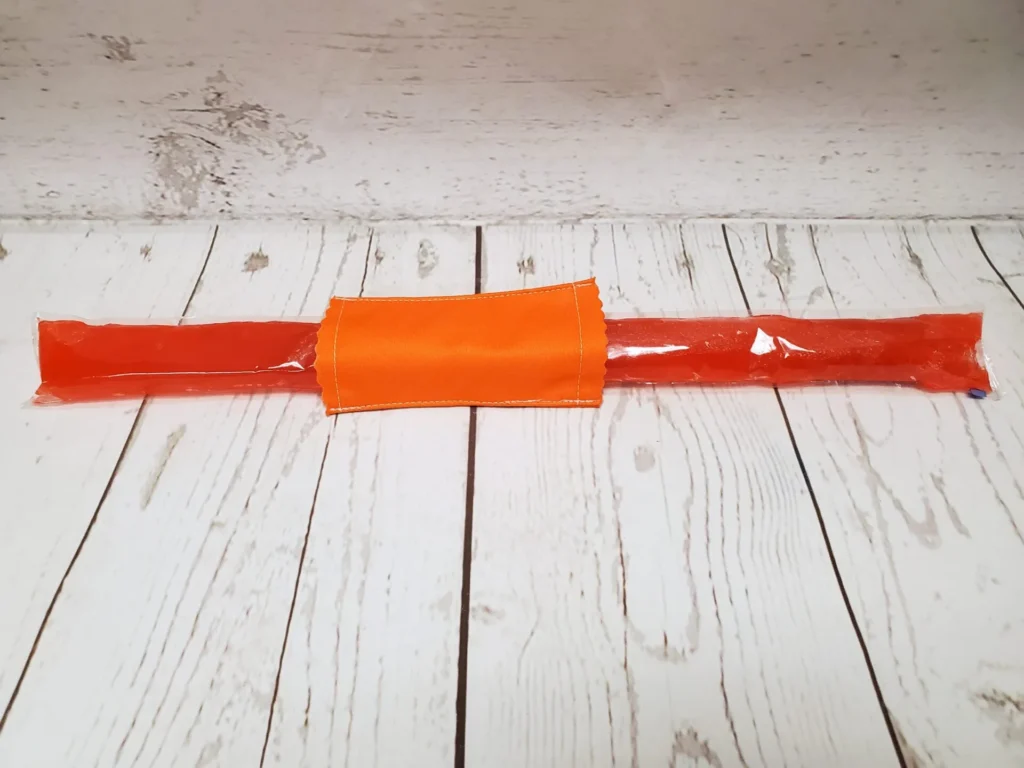 Couvre bâton glacé Taille & Retailles en tissu Orange